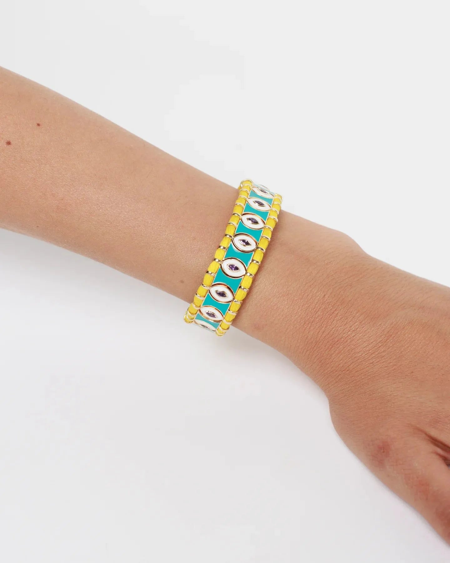 MyAleph Riviera Bracelet on wrist with yellow cotton cord, turquoise enamel details, glossy evil eye design, and adjustable fish-lock clasp