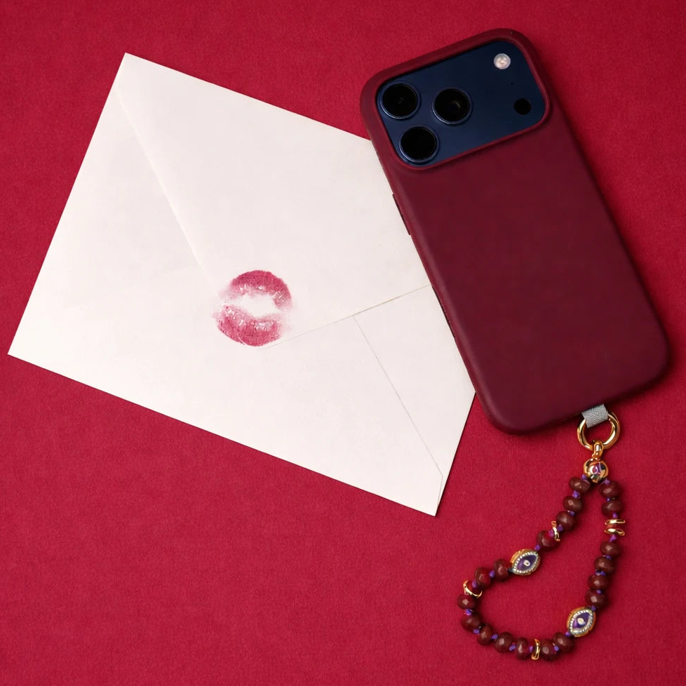 Ruby quartz Mini Leah phone charm on a red background