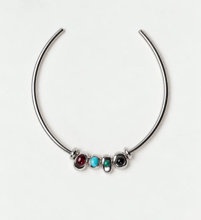 Silver Terre Necklace with garnet, turquoise, malachite and onyx charms on an open choker collar against a light gray background.