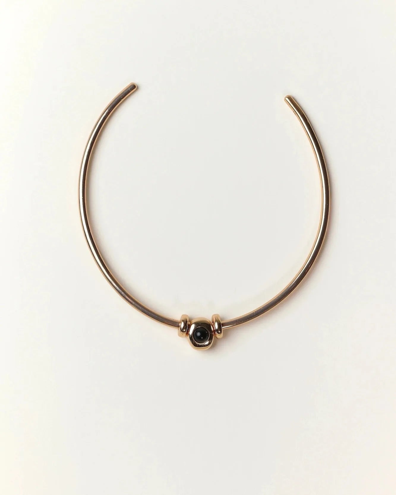 Gold Terre Necklace styled with onyx gemstone charm representing Air