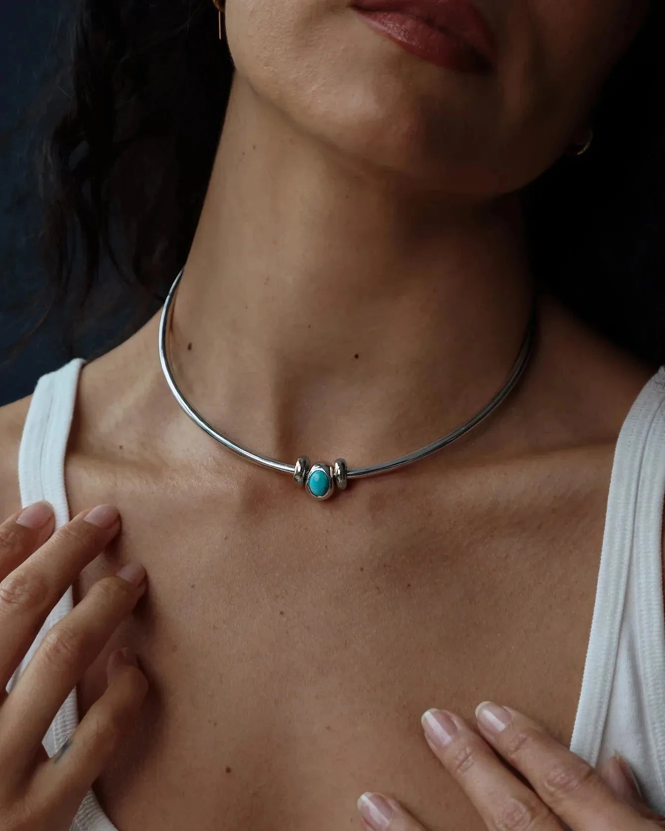 Model wearing the Terre necklace with interchangeable gemstone charms, styled as a modern elemental statement necklace.