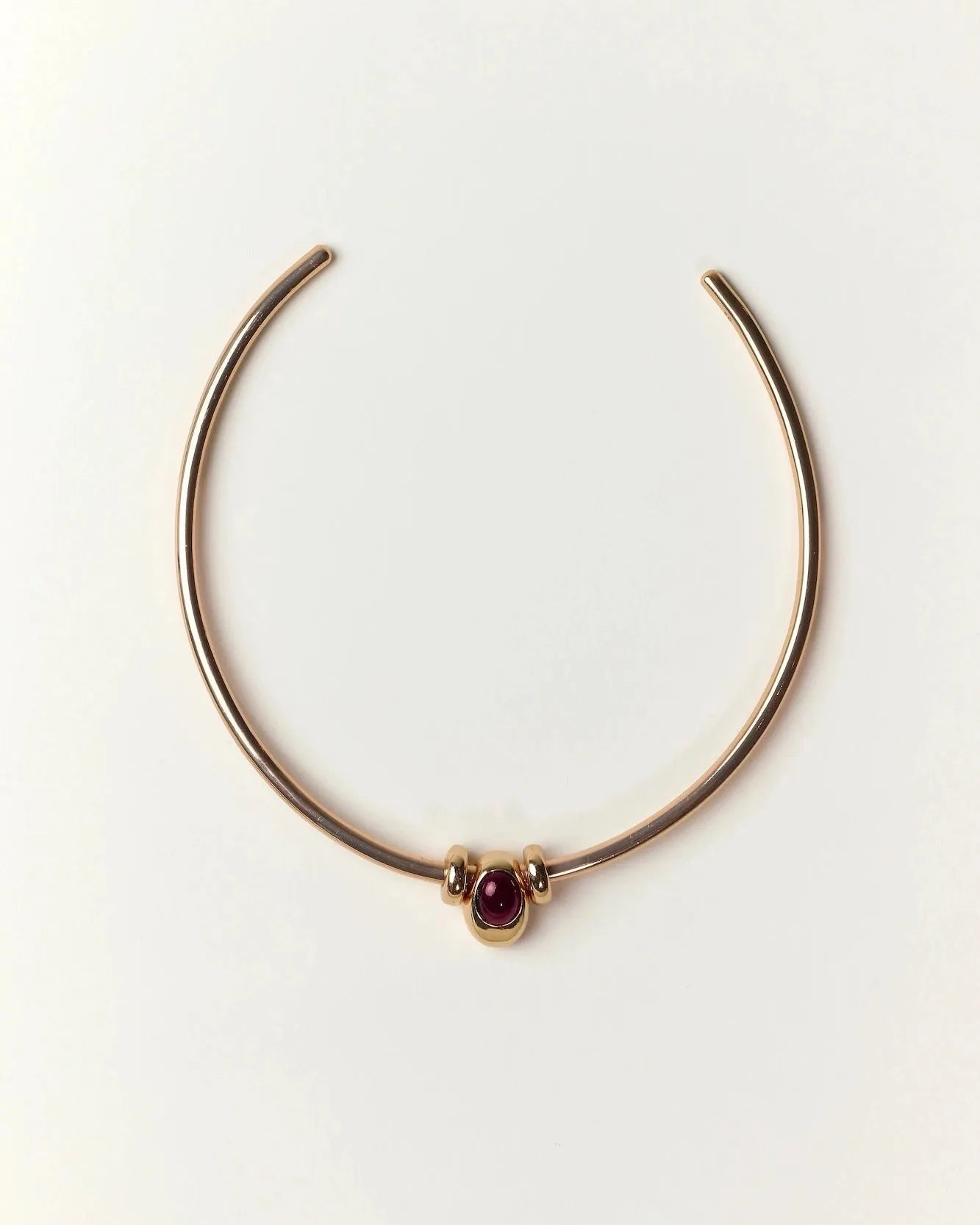 Gold Terre Necklace styled with garnet gemstone charm representing Fire