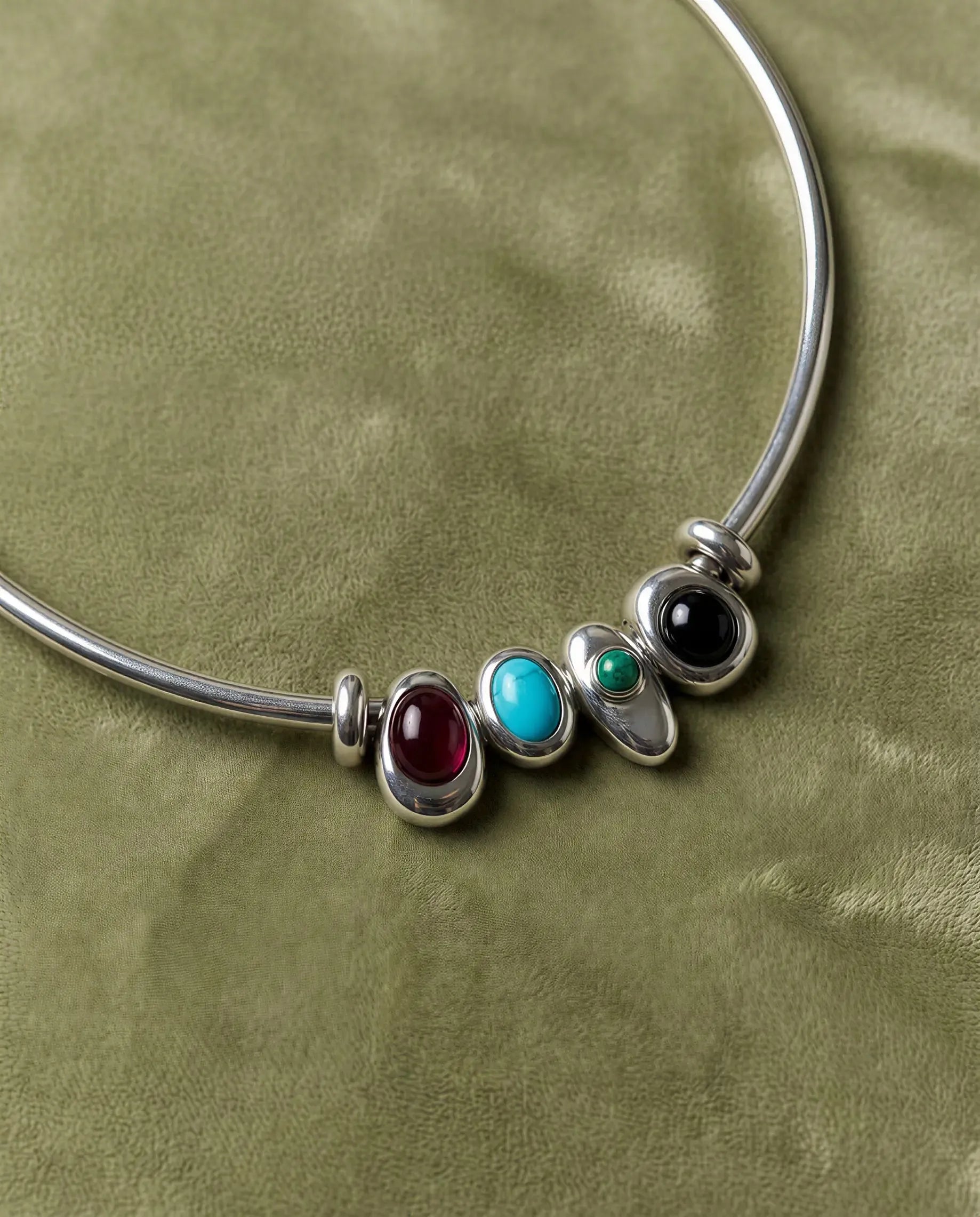 Terre necklace styled with all four interchangeable gemstone charms representing the elements of fire, water, earth, and air.