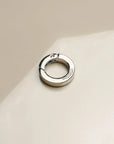 Detailed image of 'The Ring' accessory in silver, highlighting its smooth finish and functional clasp, perfect for integrating with phone wristlets and charms.