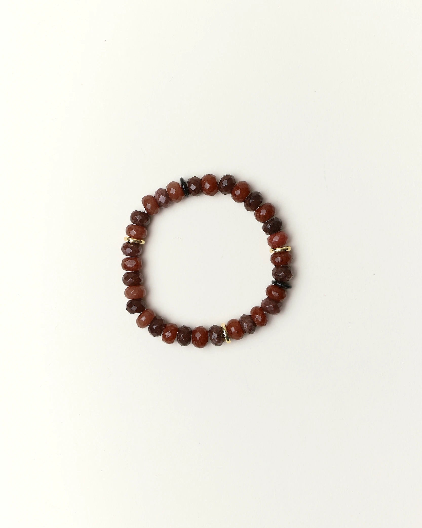 espresso quartz beaded bracelet with gold spacer details photographed in a full flat lay on a soft cream background