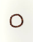 espresso quartz beaded bracelet with gold spacer details photographed in a full flat lay on a soft cream background