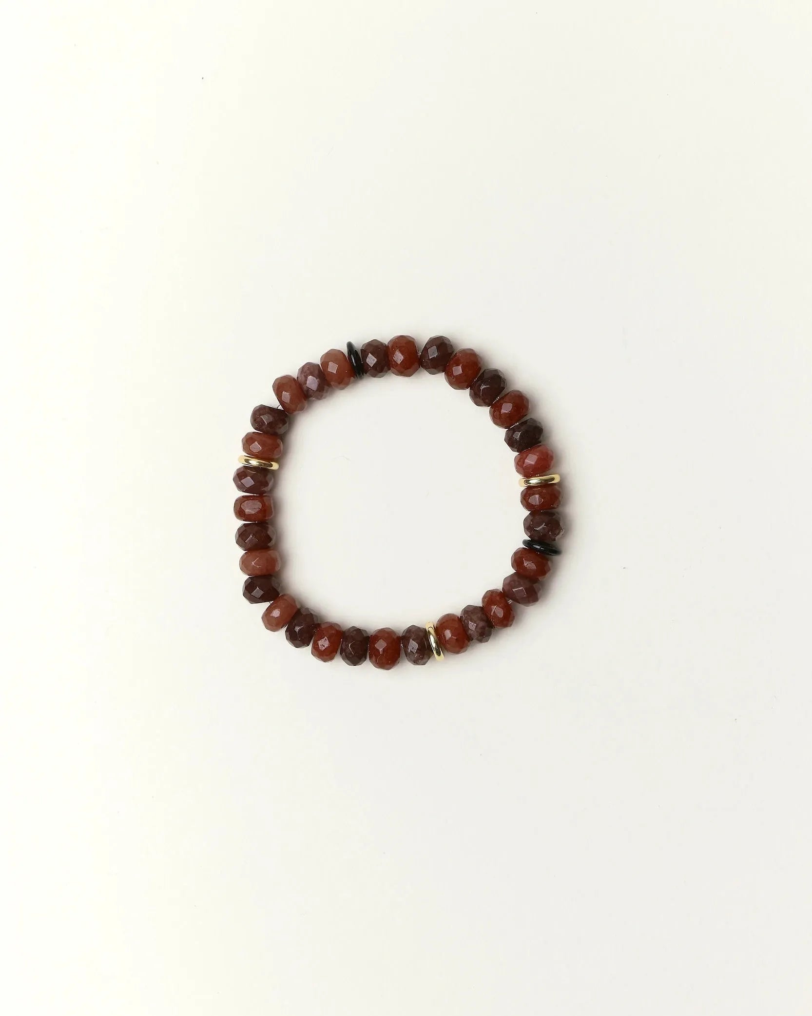espresso quartz beaded bracelet with gold spacer details photographed in a full flat lay on a soft cream background