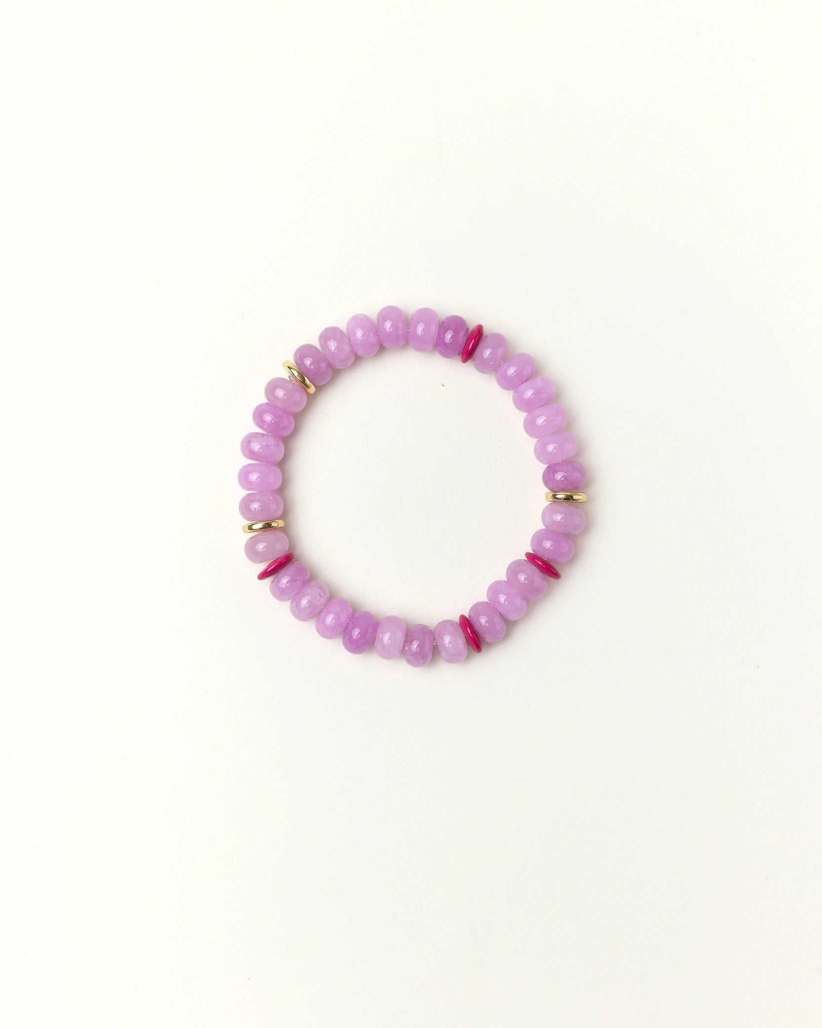 Lavender quartz beaded bracelet with gold spacer details photographed in a full flat lay on a soft cream background