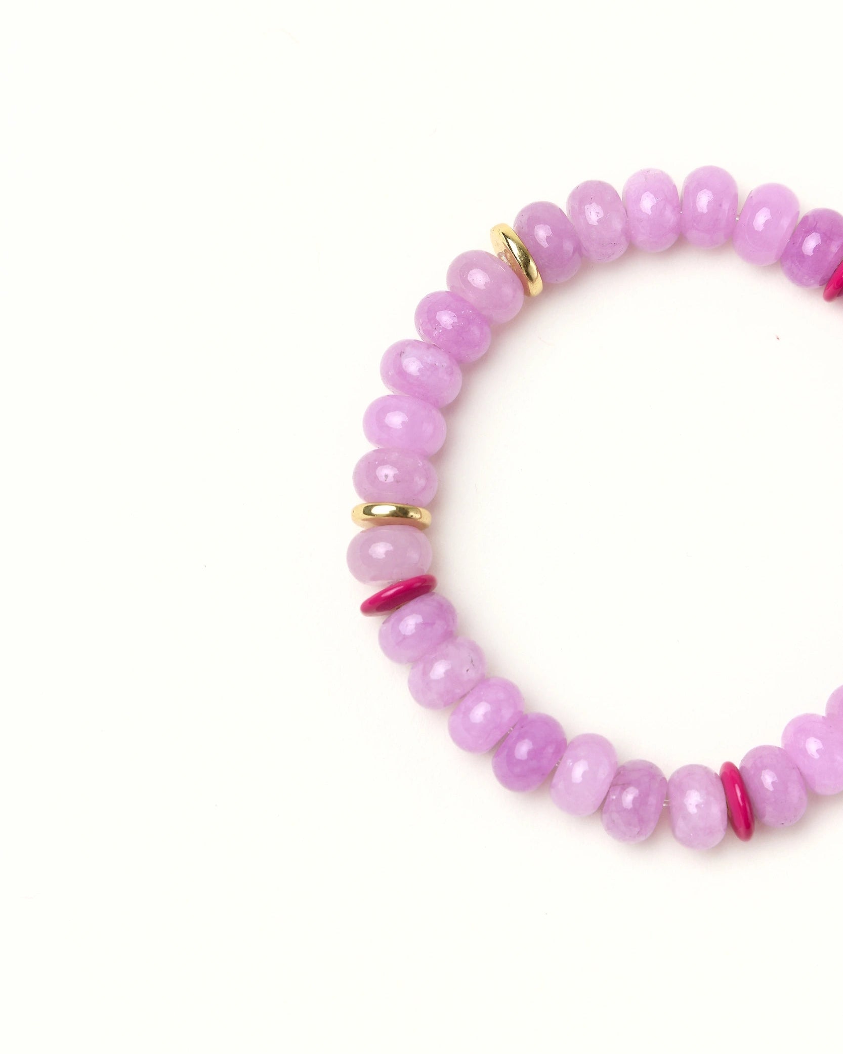 Close-up flat lay of Lavender quartz beaded bracelet with gold spacer accents on a soft cream background