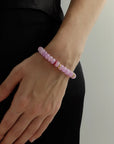 Lavender quartz beaded bracelet with gold accents worn on wrist, soft purple gemstone bracelet styled for everyday layering