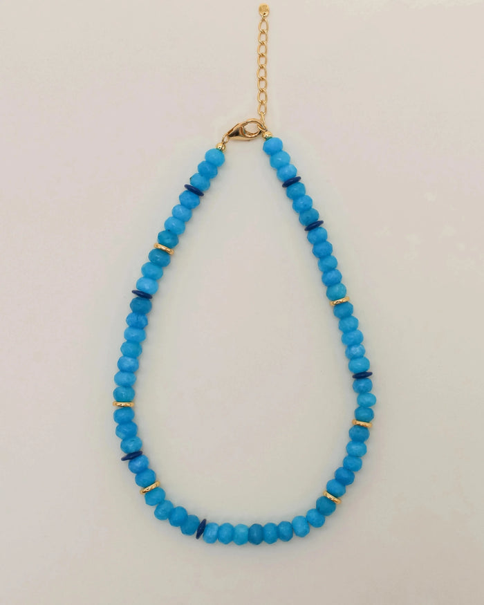 Azure Valerie Necklace with vibrant blue beads and gold accents, featuring an adjustable gold chain for versatile wear.