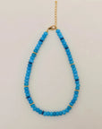 Azure Valerie Necklace with vibrant blue beads and gold accents, featuring an adjustable gold chain for versatile wear.