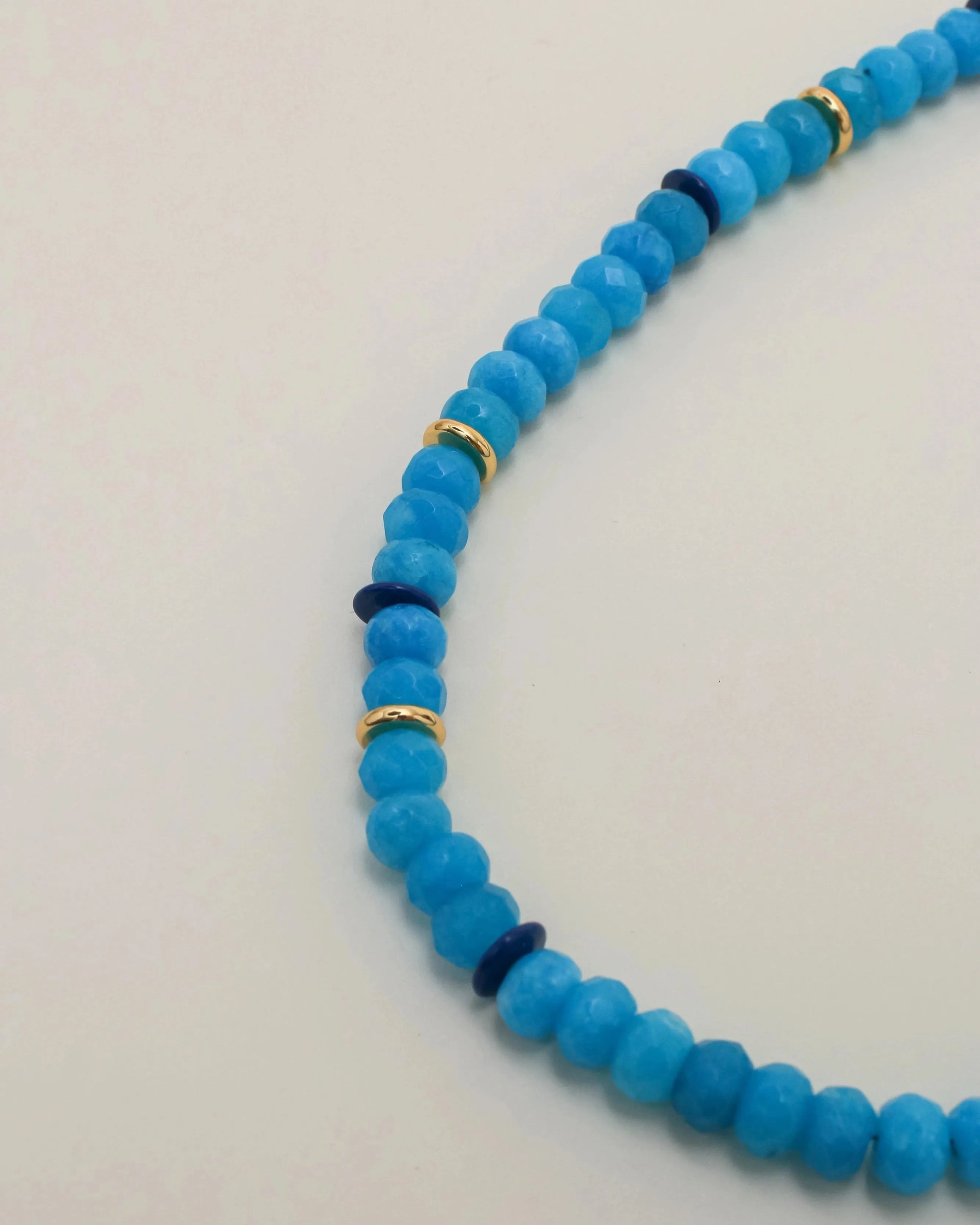 Close-up of the Azure Valerie Necklace highlighting its polished beads and delicate gold details.