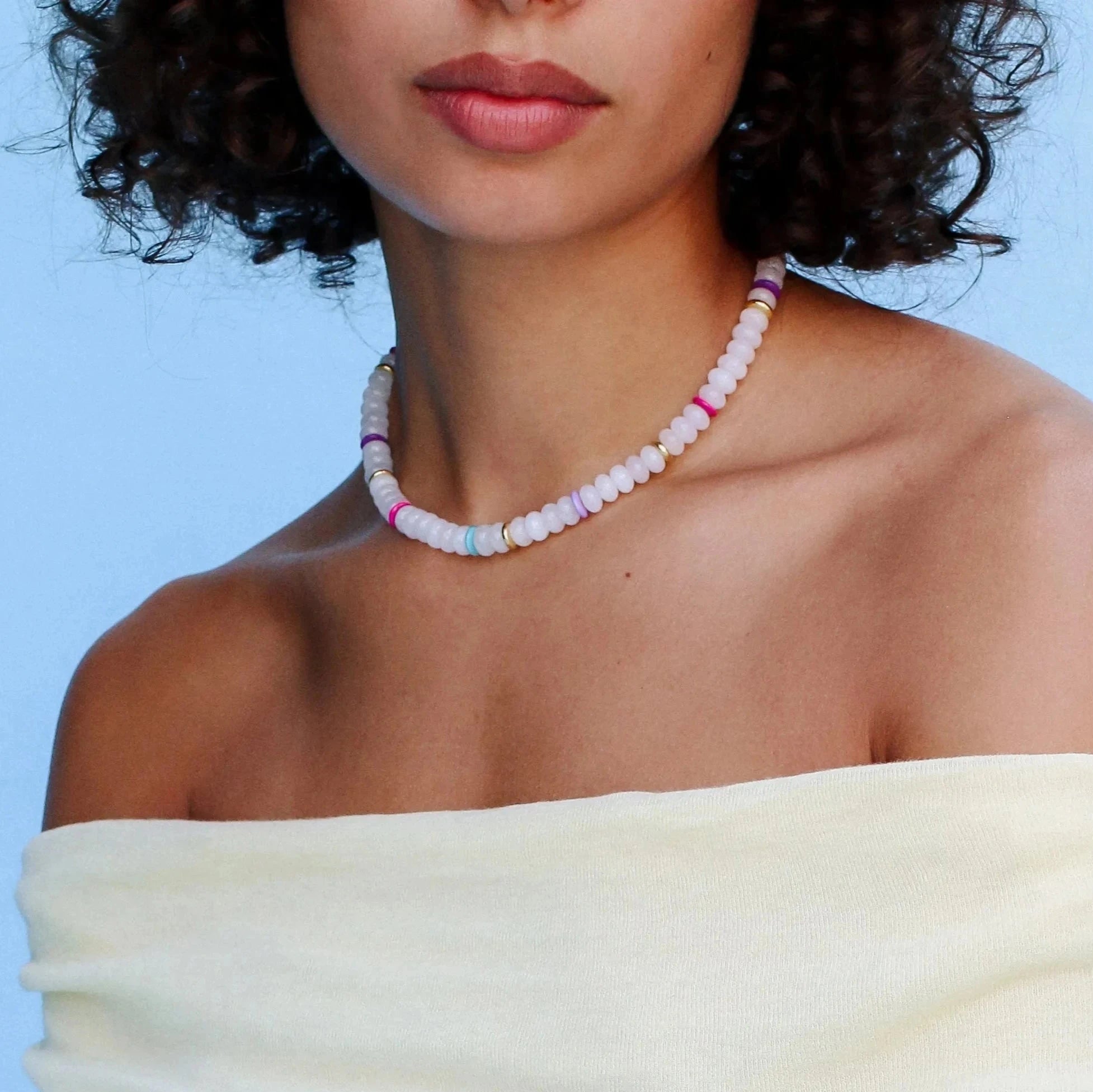 Model wearing the Valerie white quartz necklace, styled to highlight its elegant white beads and colorful dividers, adding a chic and sophisticated look.