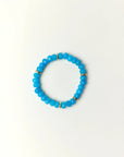 Zoe Azure quartz beaded bracelet with gold spacer details photographed in a full flat lay on a soft cream background