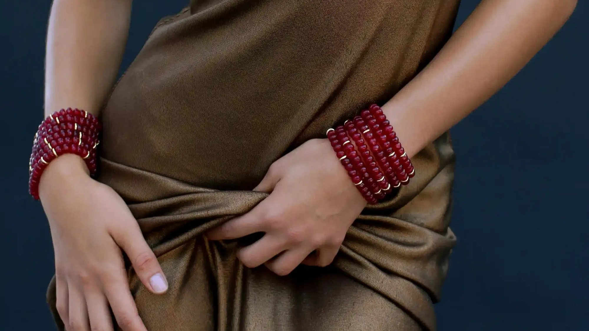 Zoe bracelets in cherry quartz, styled as a stack, symbolizing courage and vitality.