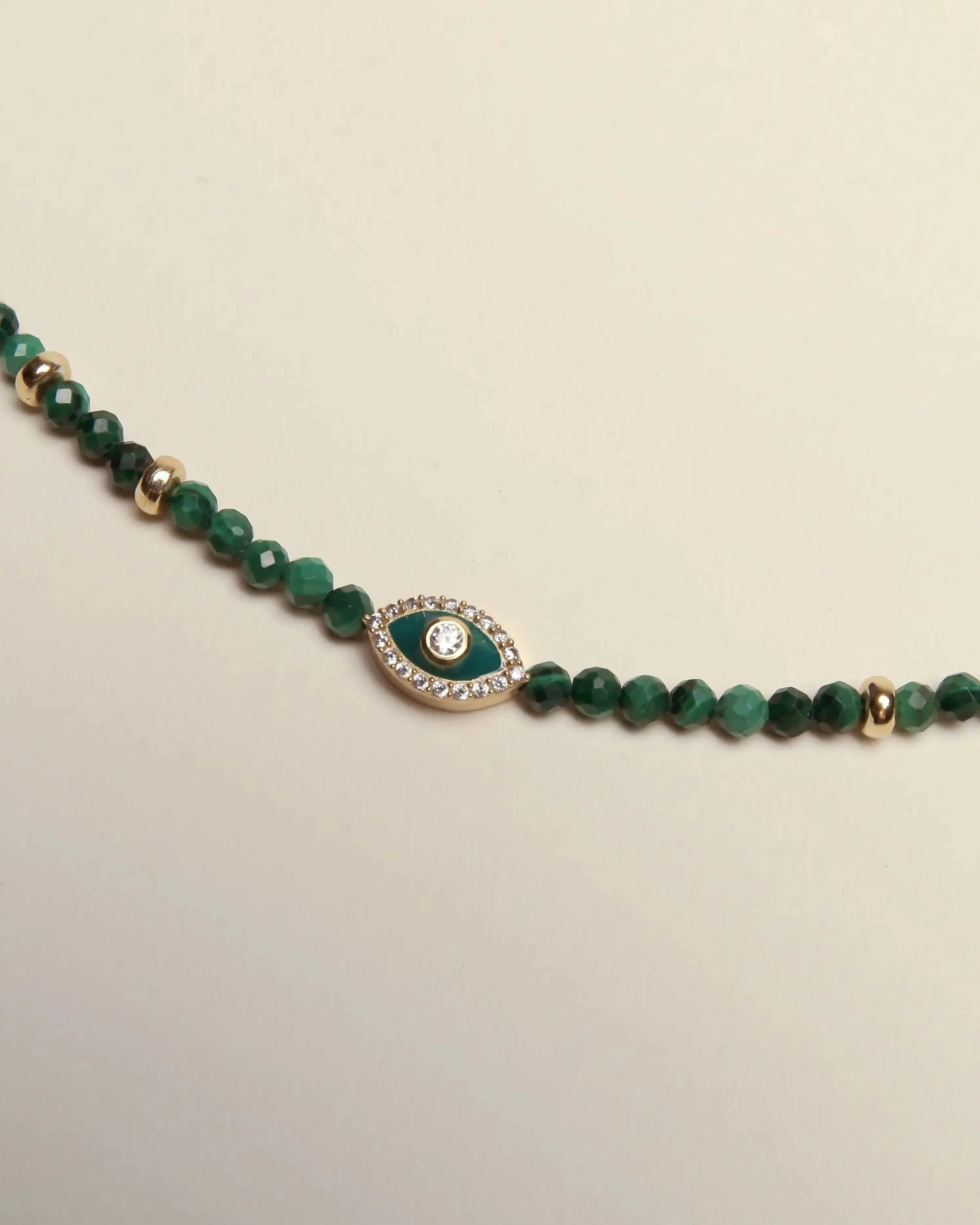 Close-up detail of the Juliana Necklace centerpiece, featuring the navy enamel evil eye with CZ sparkle and gold-plated accents.