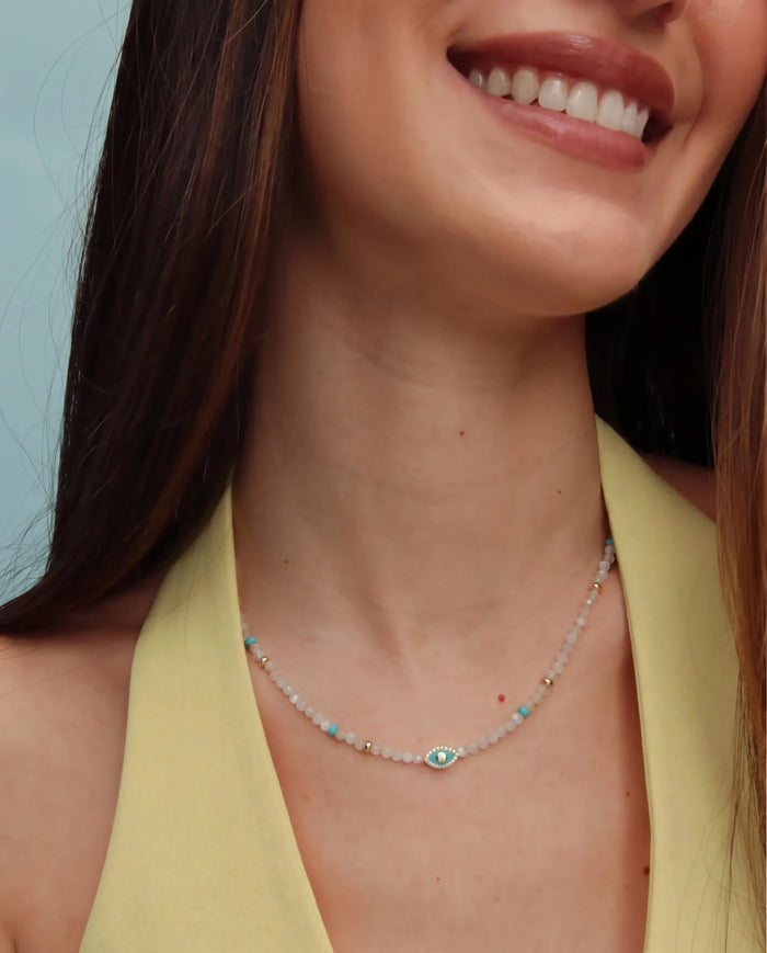 Model wearing the Juliana Necklace in Moonstone, styled with a yellow top for a warm, elevated look.