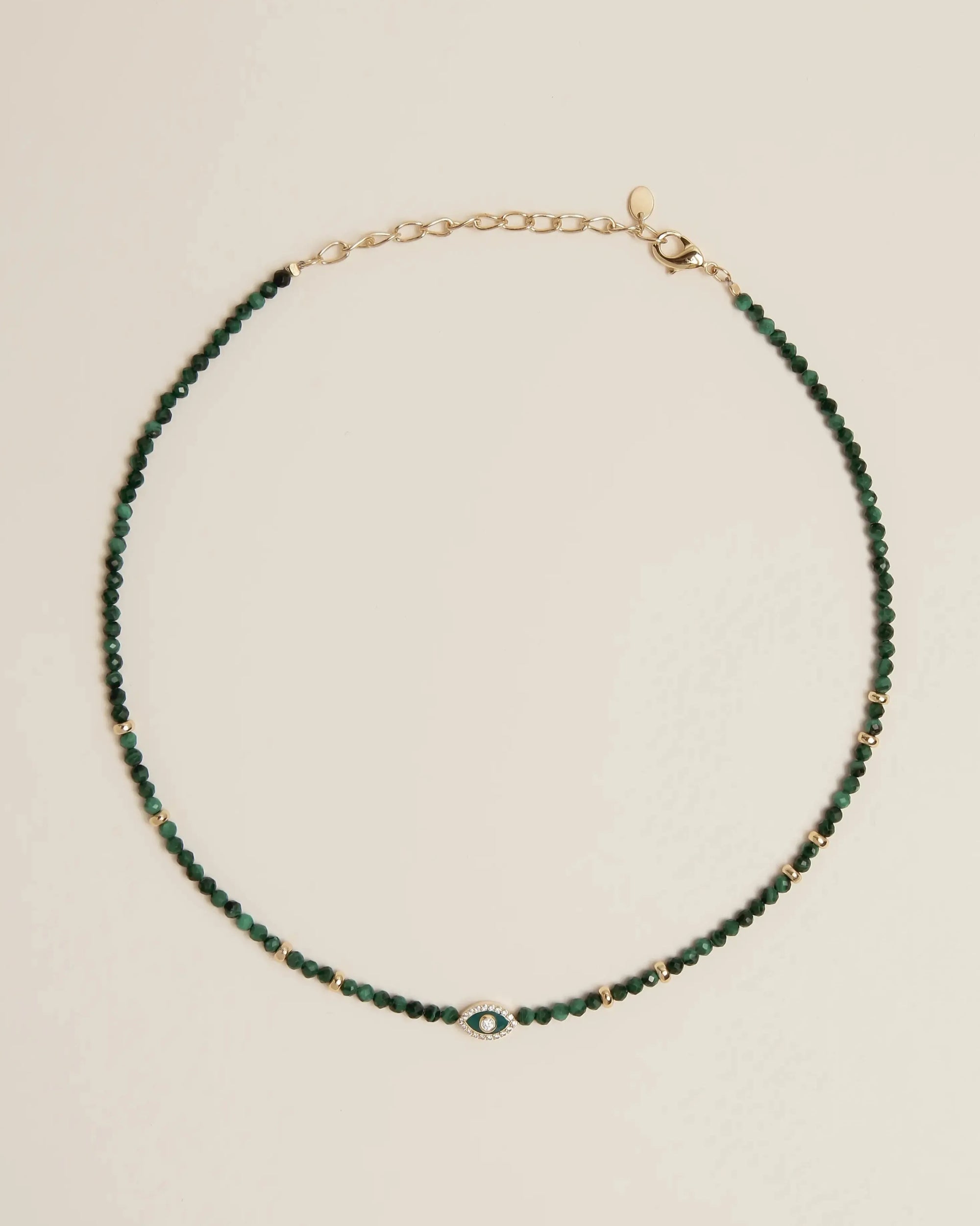 Flatlay of the Julianna Necklace in Malachite, showcasing deep green malachite beads and gold-plated adjustable clasp.