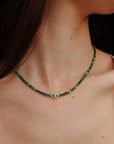 Side view of model wearing the Julianna Necklace in Malachite, showing how the necklace contours the neckline.