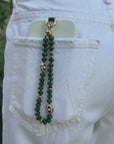 model using the emerald leah phone charm with evil eye charms